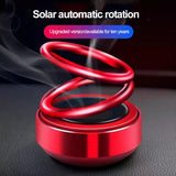 Solar powered car perfume rotating diffuser on dashboard