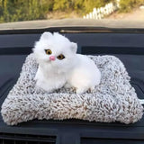 Cute sleeping cat plush dashboard decoration at Shark Auto