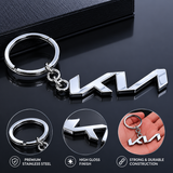 Kia logo keychain and metal emblem on a dark surface with product features highlighted.